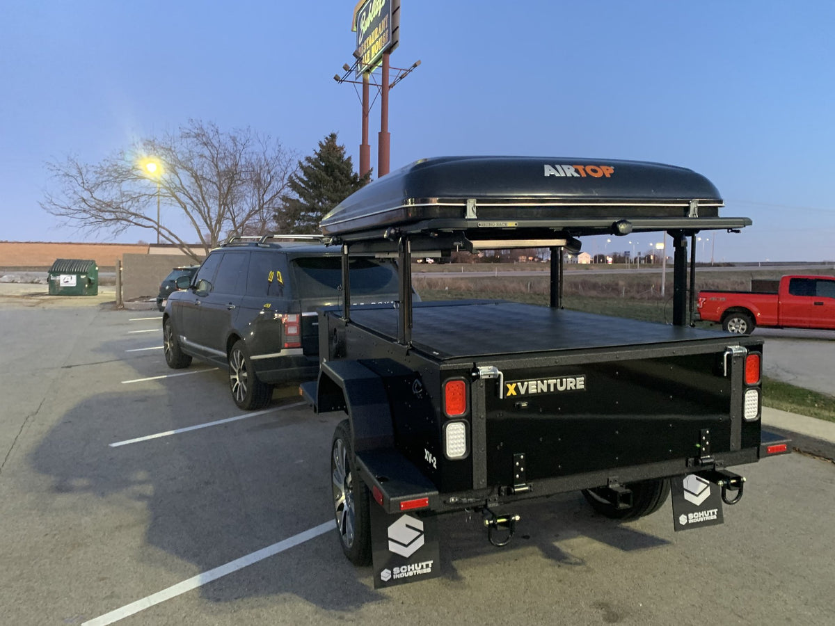 Rear view of the trailer showing the XVENTURE tailgate, taillights and the Airtop 360 shell mounted overhead — photo 15
