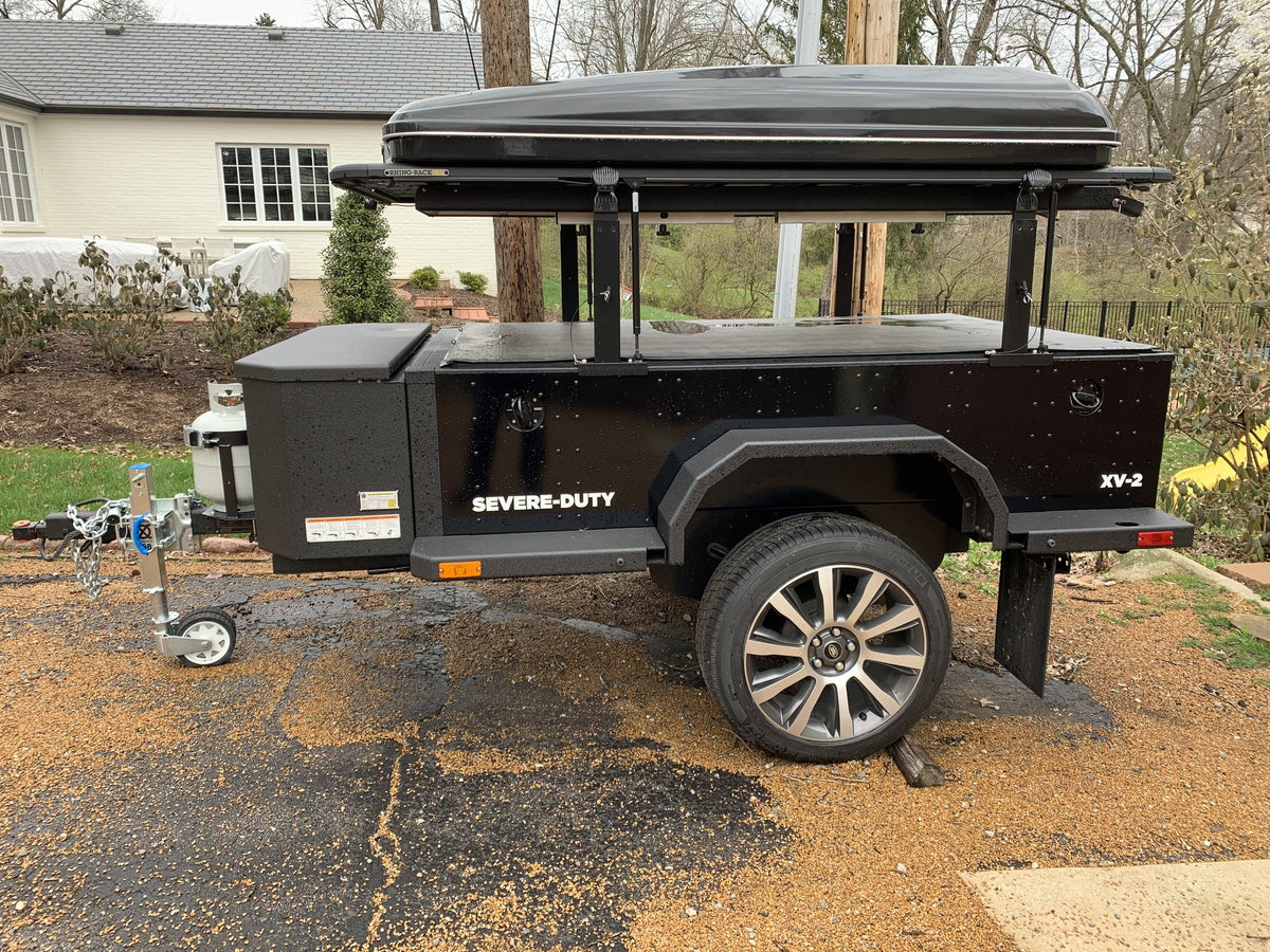 Passenger-side view of the XV-2 on a driveway with the awning mounted along the roof rack — photo 5