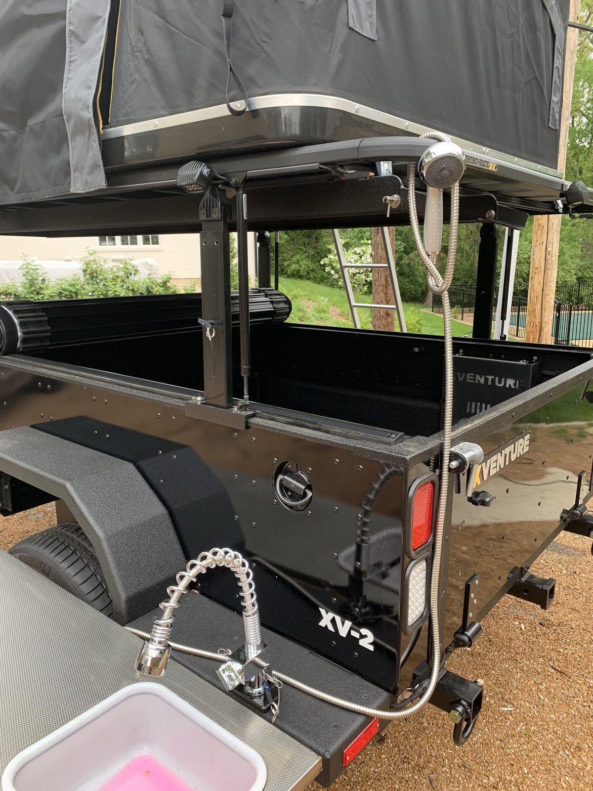 Rear of the XV-2 with the tailgate down and the galley sink faucet and pull-out shower hose extended — photo 3