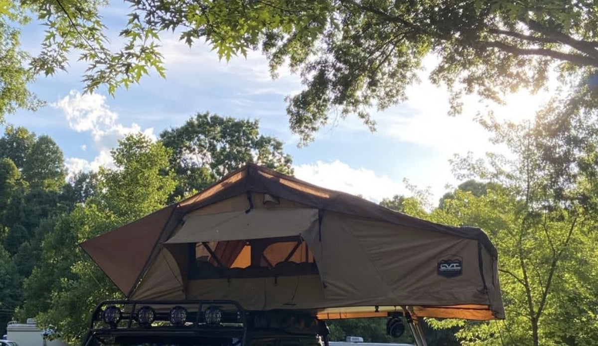 Side profile of the open CVT rooftop tent with the rainfly extended and CVT badge visible — photo 2