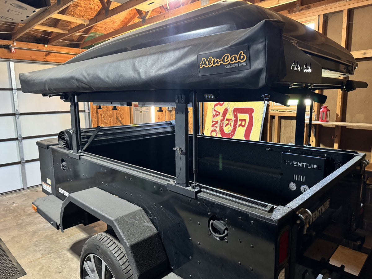 Full side view of the XV-2 with the Alu-Cab Shadow Awn 270 awning stowed in its bag on the roof rack — photo 18