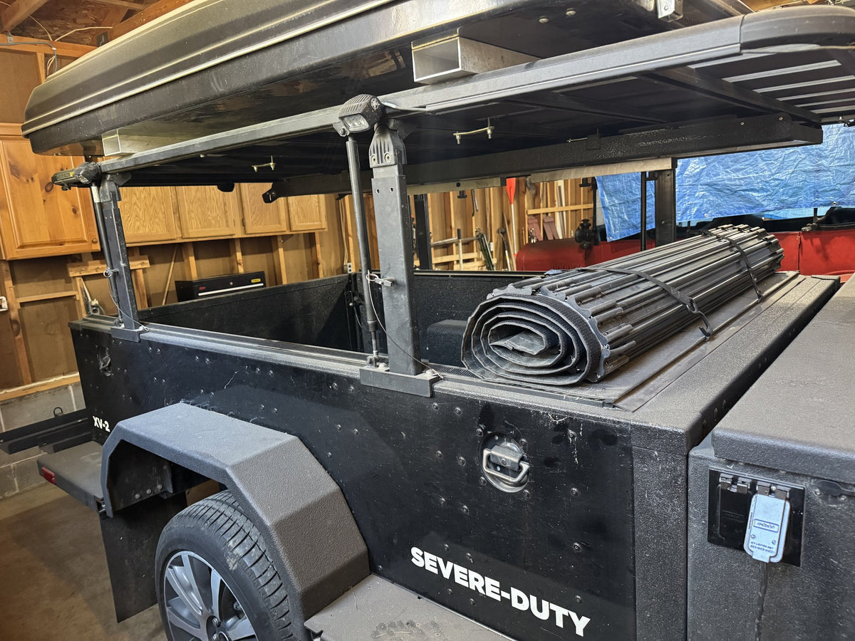 Rear three-quarter view of the XV-2 in the garage with the roll-top tonneau cover rolled back, showing the cargo bed and side boxes — photo 19