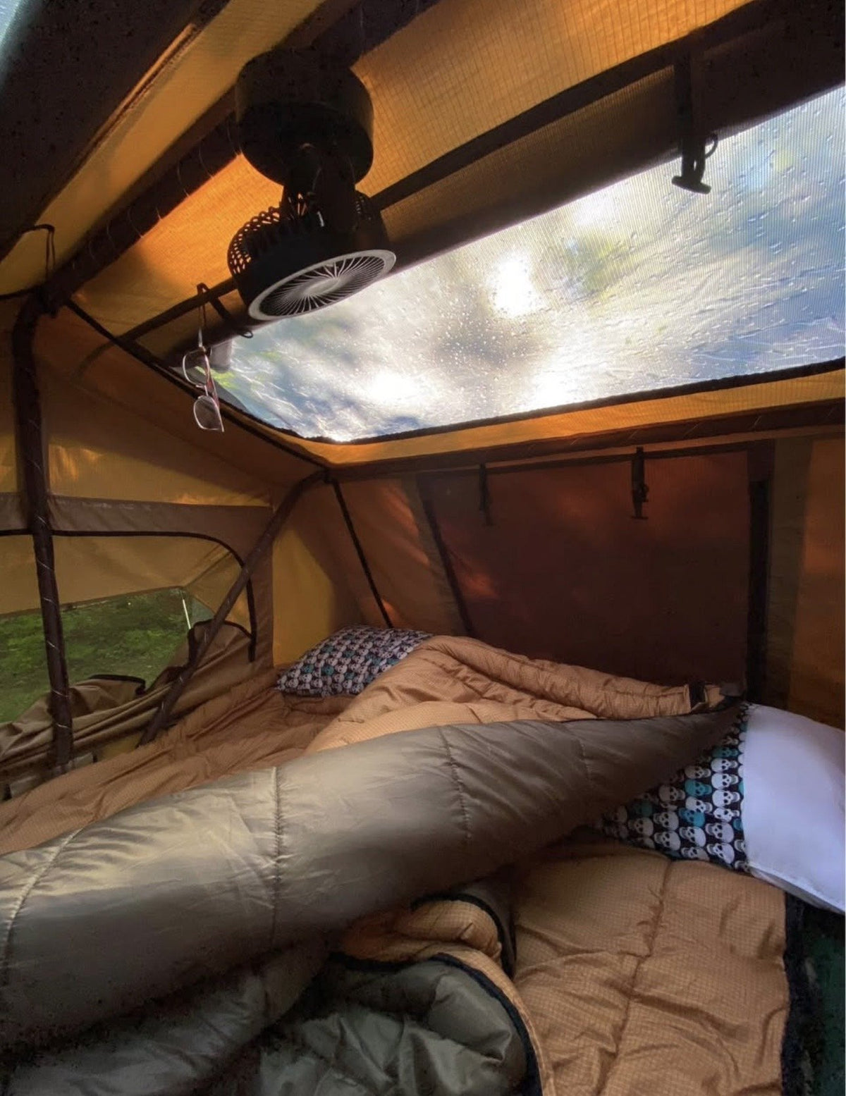 Interior of the rooftop tent showing the mattress, skylight window and headroom — photo 3