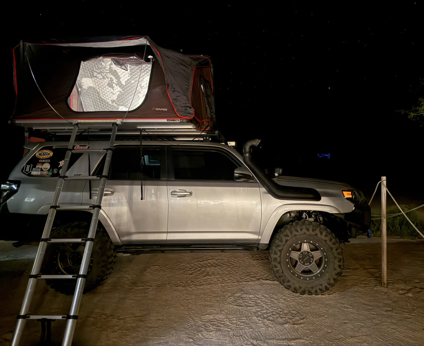 iKamper rooftop tent deployed at a night campsite — photo 11