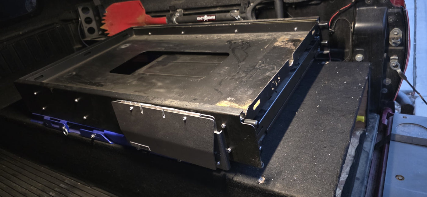 Detail of the OVS slide deck in the truck bed, showing the wash tub cutout and hinged fold-down panel — photo 5