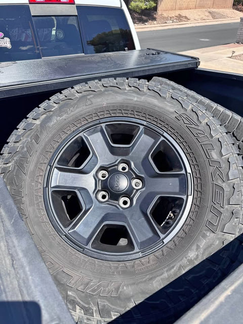 Four Jeep Rims with tires
