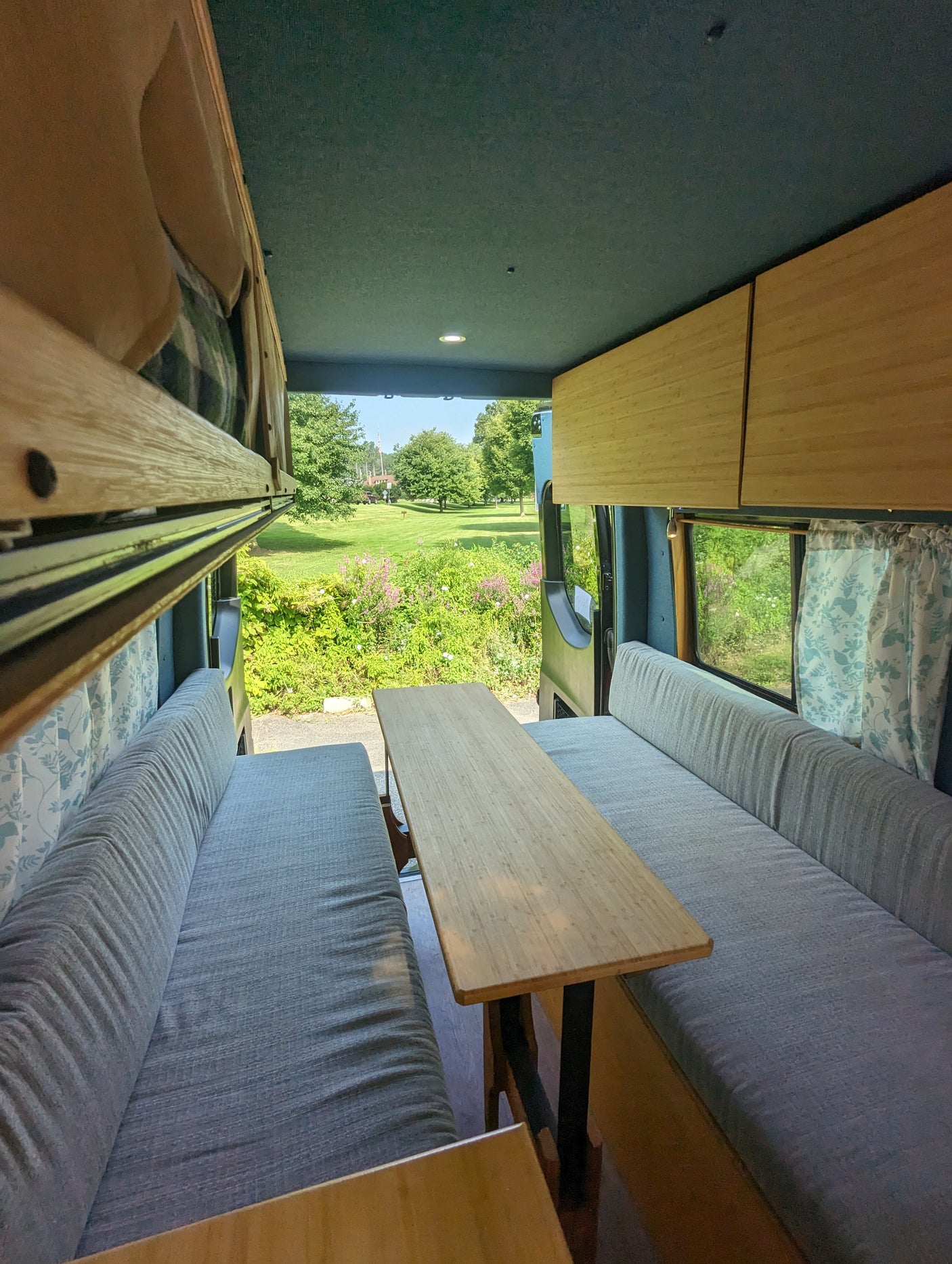 and comfortable seating leading to scenic views.|Spacious RV rental interior featuring bamboo cabinetry