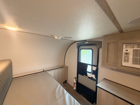 featuring a spare tire and propane tank. Great for camping adventures.|This rugged white and black XPLORER off-road RV trailer — photo 8
