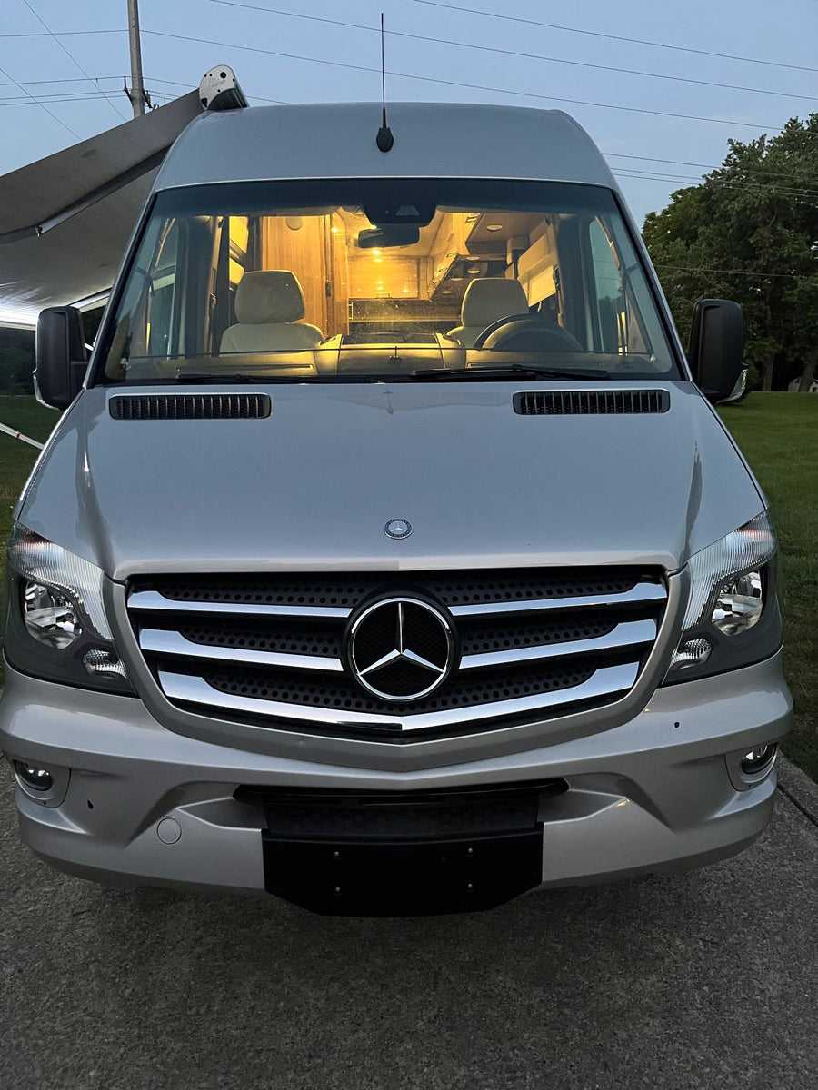 ready for your adventure.|Spacious RV interior with swiveling captain's chairs and a full kitchen