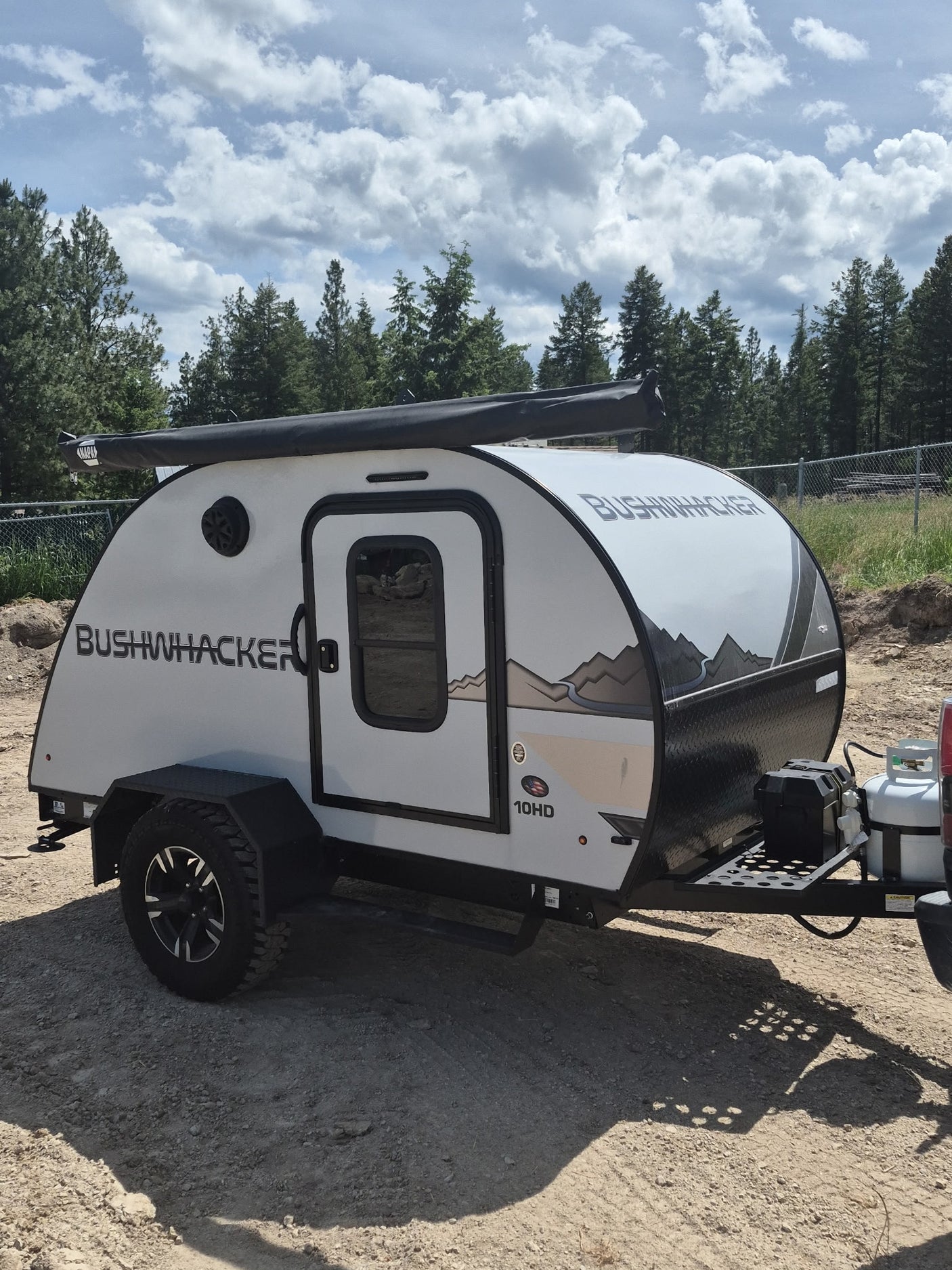 This Bushwhacker 10HD teardrop RV rental is a rugged camping trailer with an awning
