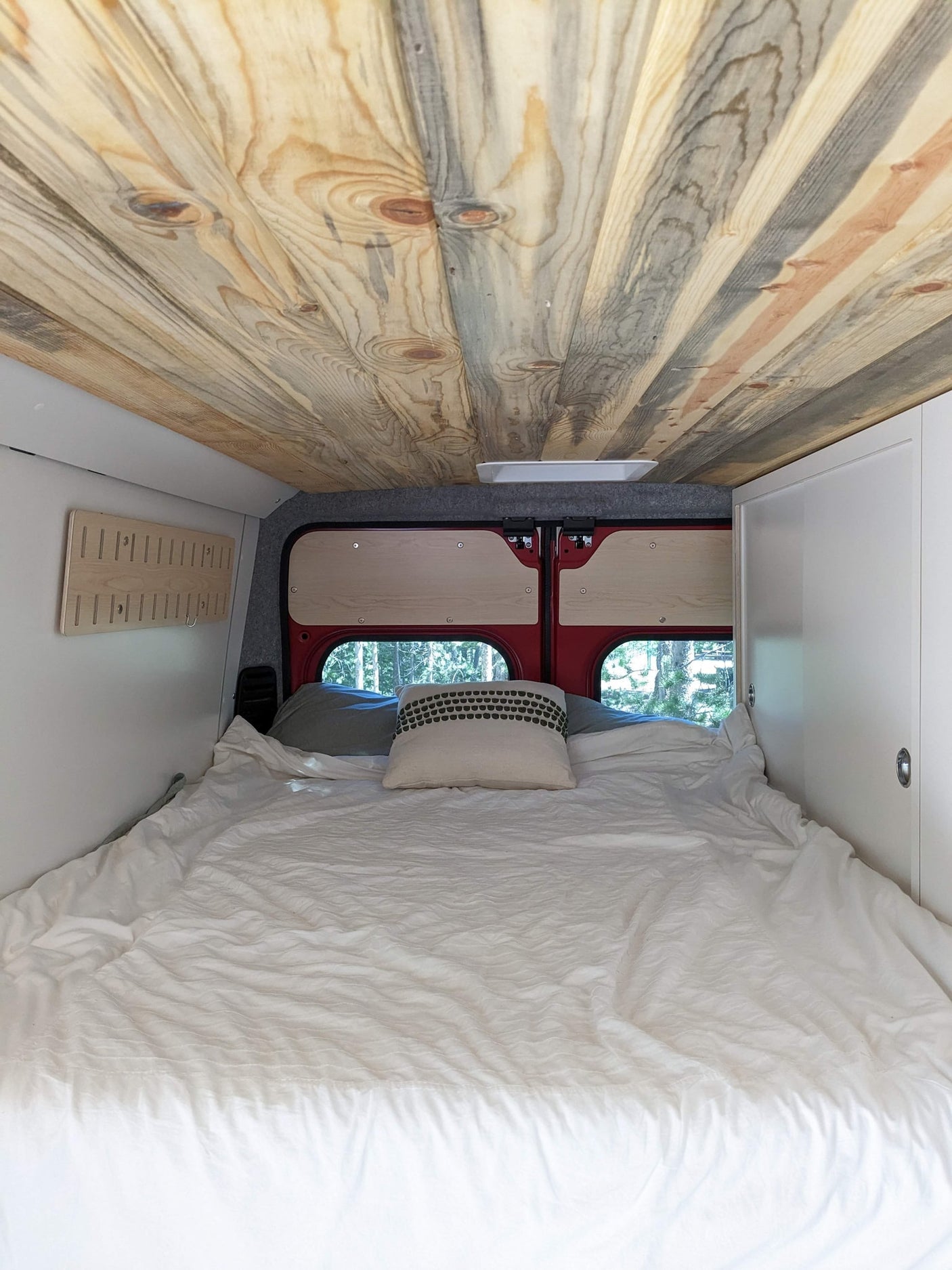 with a stunning mountain view.|A red Dave & Matt's RV rental van with two mountain bikes