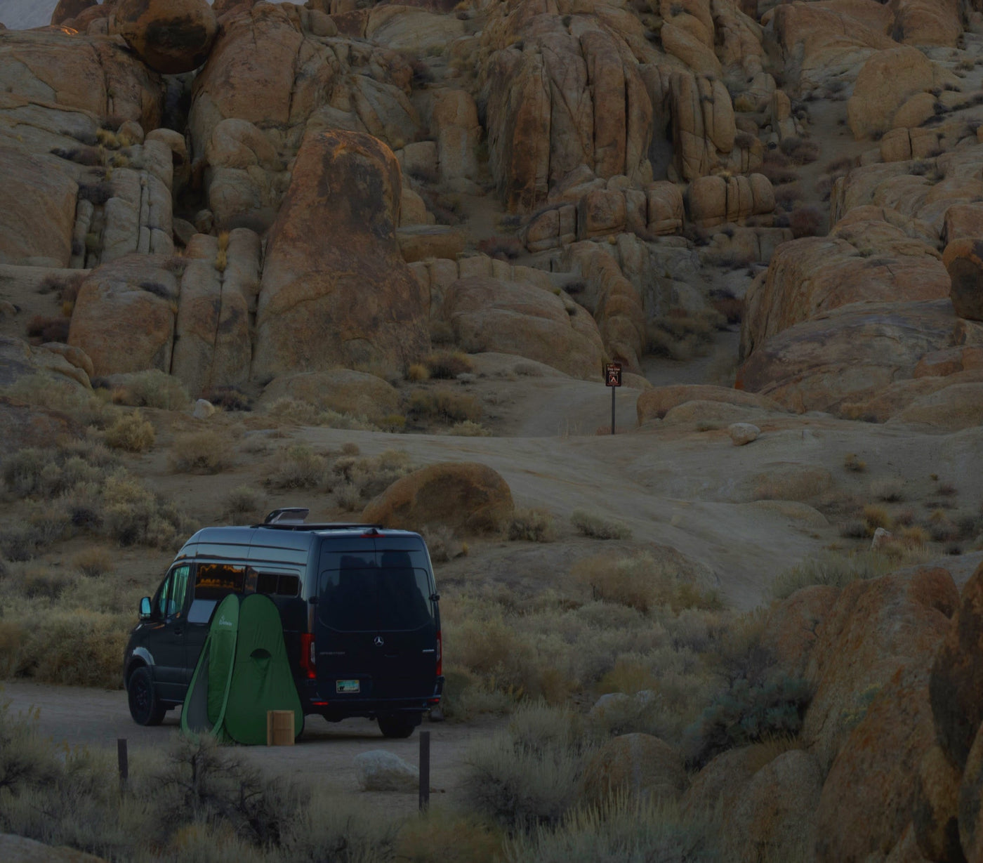and overhead storage.|Black RV rental van by a serene lake at sunset — photo 4