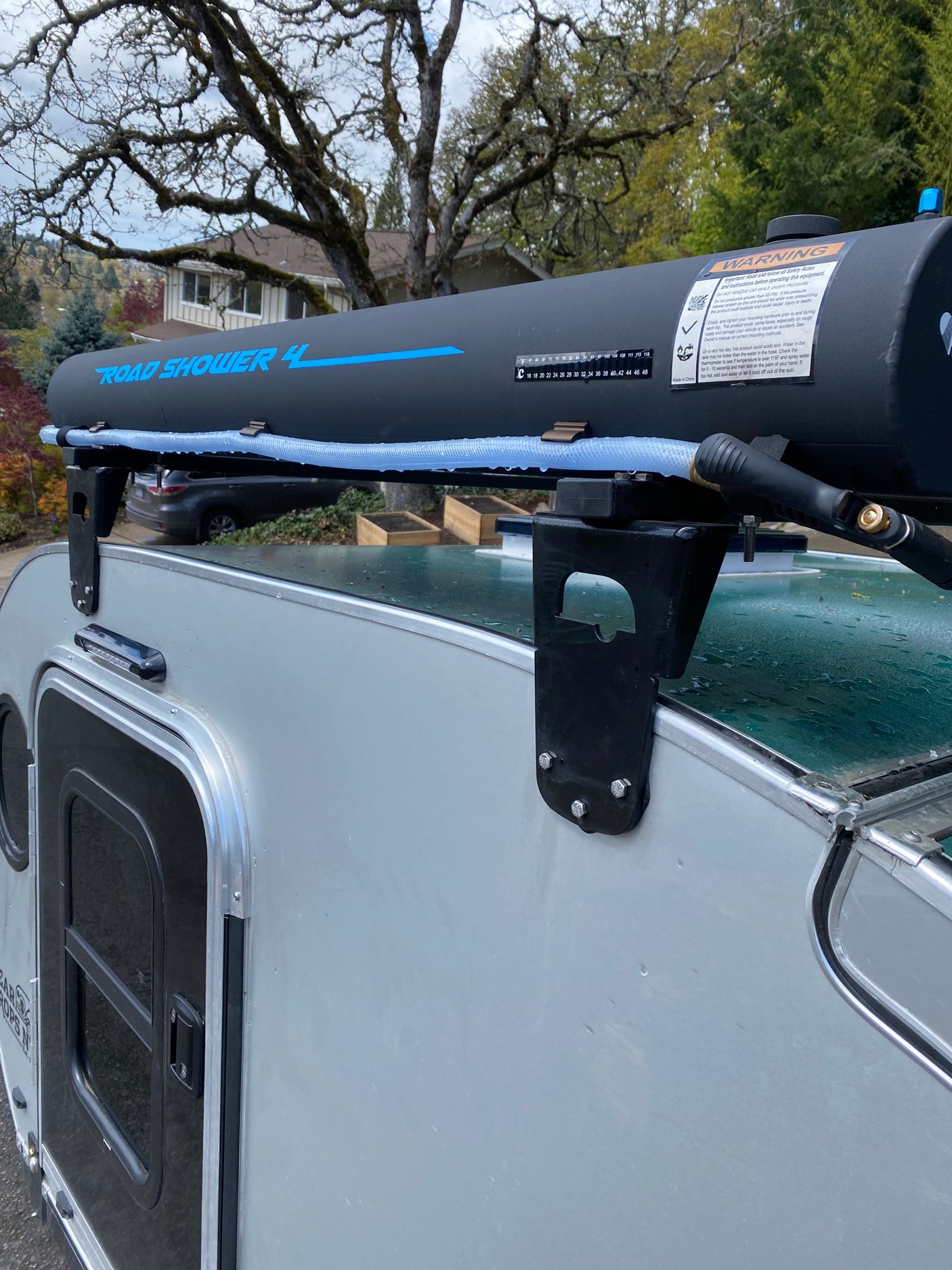 RV rental featuring a roof-mounted Road Shower 4 water tank, providing convenient outdoor hot water for campers.