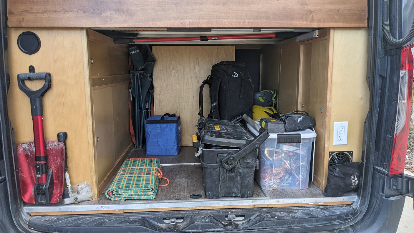 RV rental rear storage: Shovels, chairs, toolboxes, and climbing gear neatly stored for your next adventure.