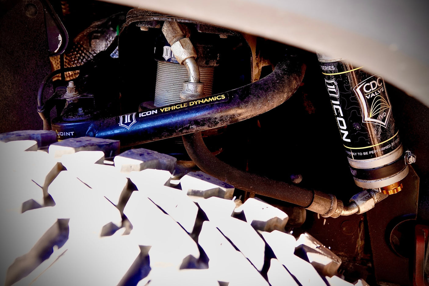 Heavy-duty ICON Vehicle Dynamics suspension & rugged tire on an RV rental, featuring CDC Valve for off-road travel.