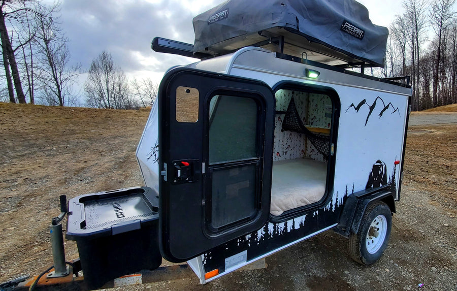 Compact overland camper with rooftop tent, ideal for your next RV rental adventure. Ready for the great outdoors!