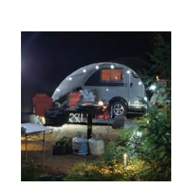 Cozy night camping setup featuring a brightly lit teardrop RV rental. Ideal for relaxed outdoor adventures.|Explore fall foliage with this nuCamp teardrop camper RV rental. Ideal for a cozy outdoor adventure.|This light-colored Boondock Edge teardrop RV rental