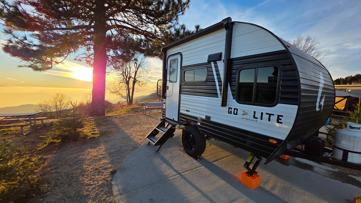 Golden hour camping with our rv rental, a Go Lite Skybreaker travel trailer, parked at a scenic site overlooking a stunning sunset. — photo 8