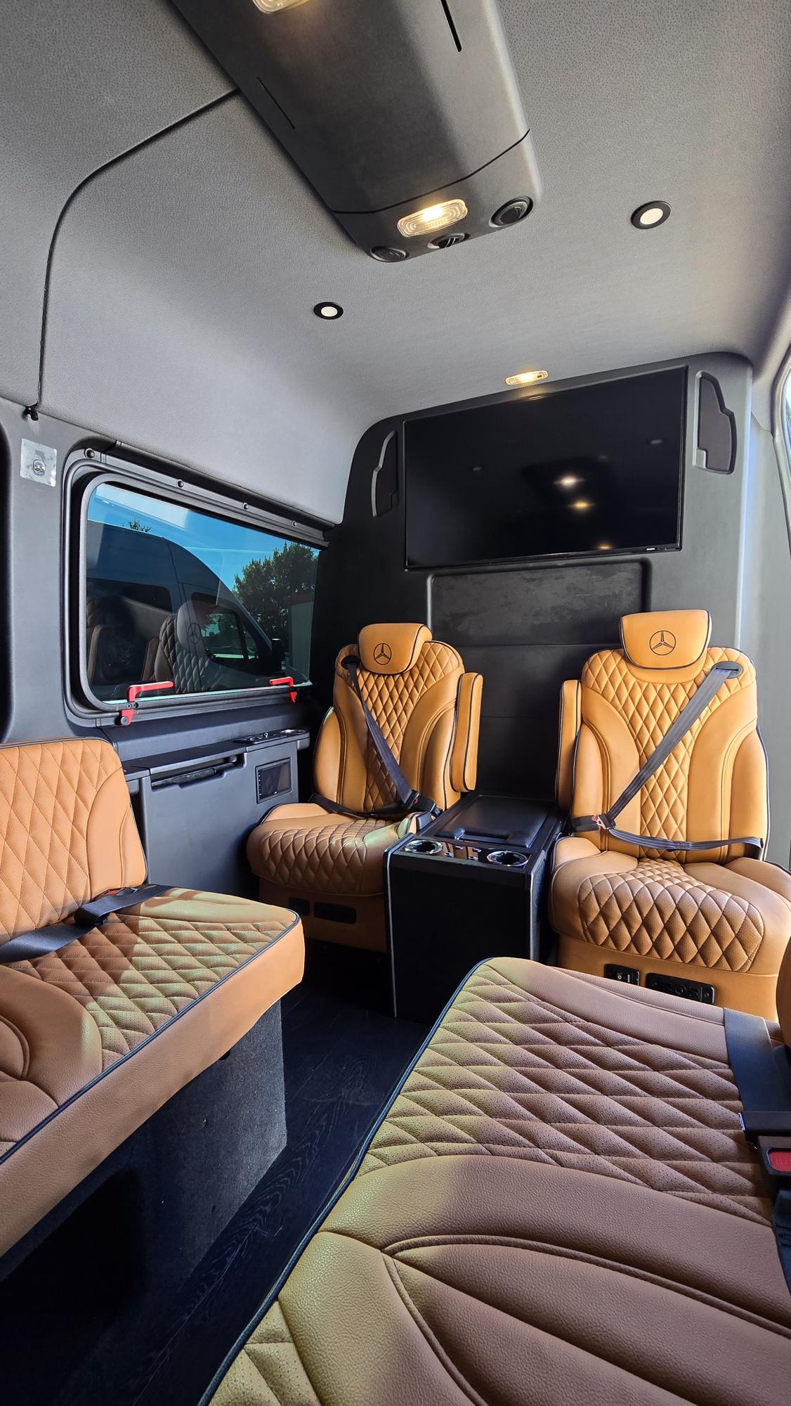 and illuminated cup holders for premium travel comfort.|Inside a luxurious RV rental: tan quilted leather seats — photo 10