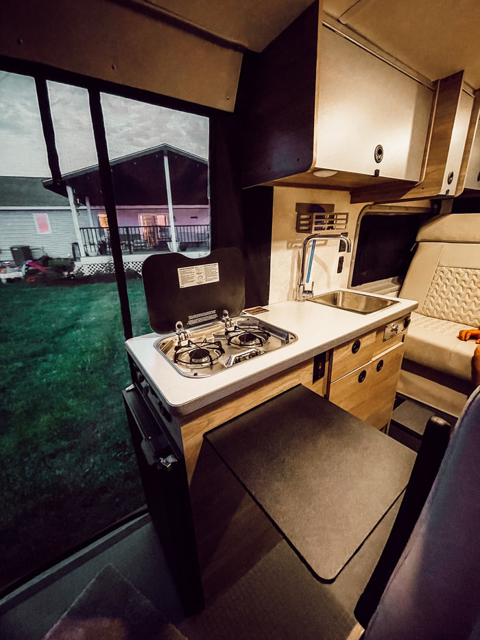 perfect for mobile adventures.|Inside an RV rental: a compact kitchenette