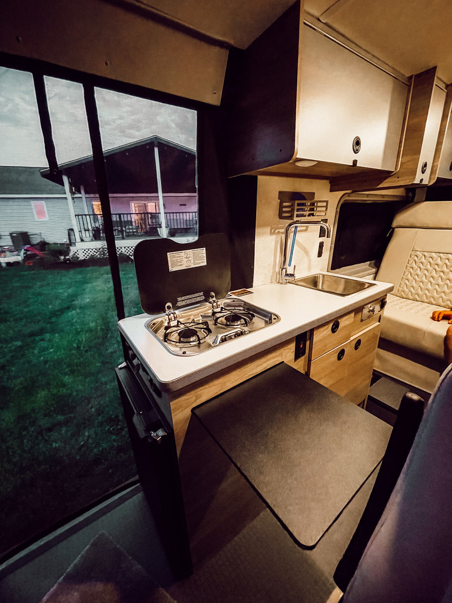 perfect for mobile adventures.|Inside an RV rental: a compact kitchenette
