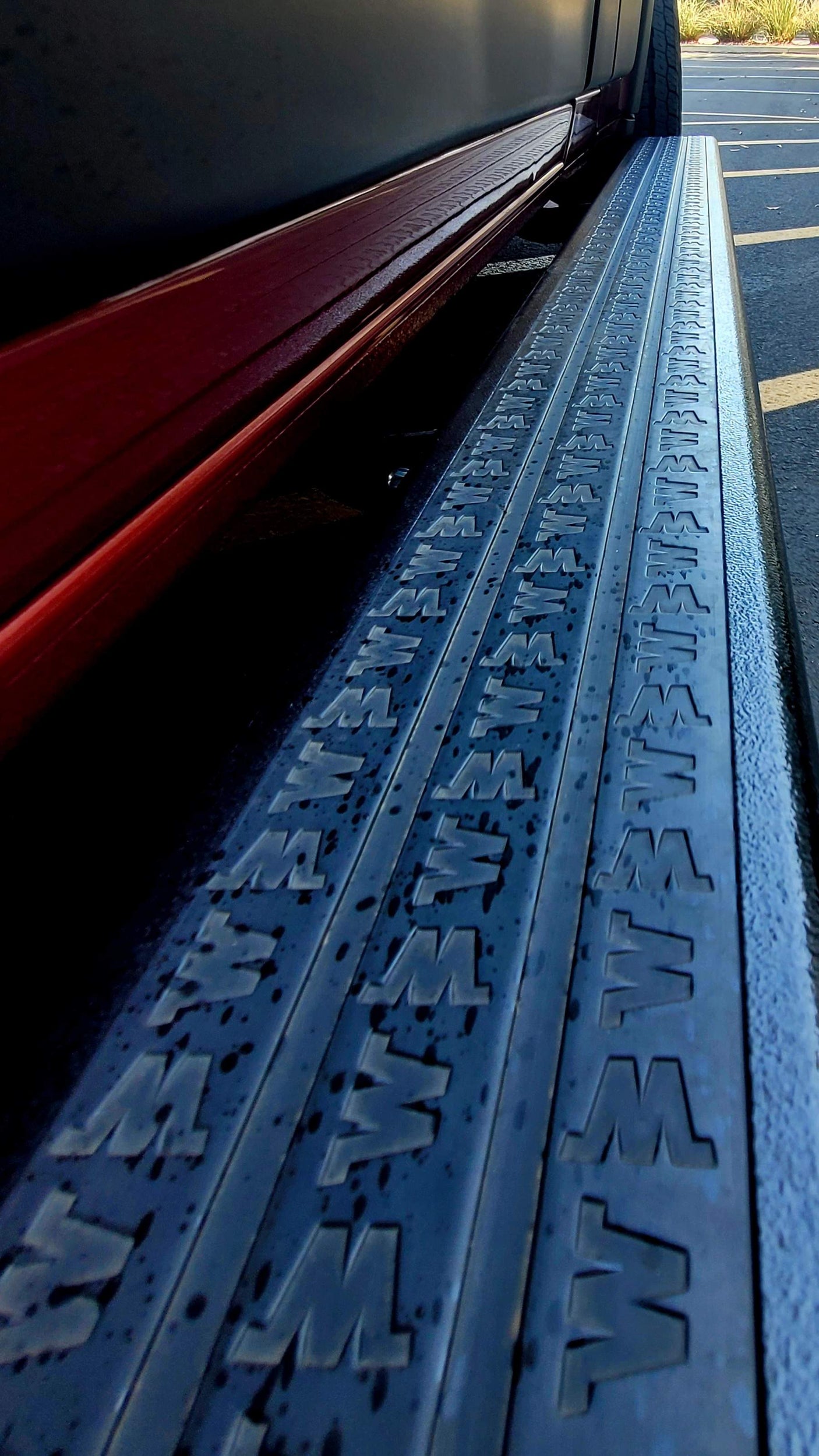 Close-up of an RV rental's side step with embossed 'W' pattern for secure footing, enhancing accessibility.