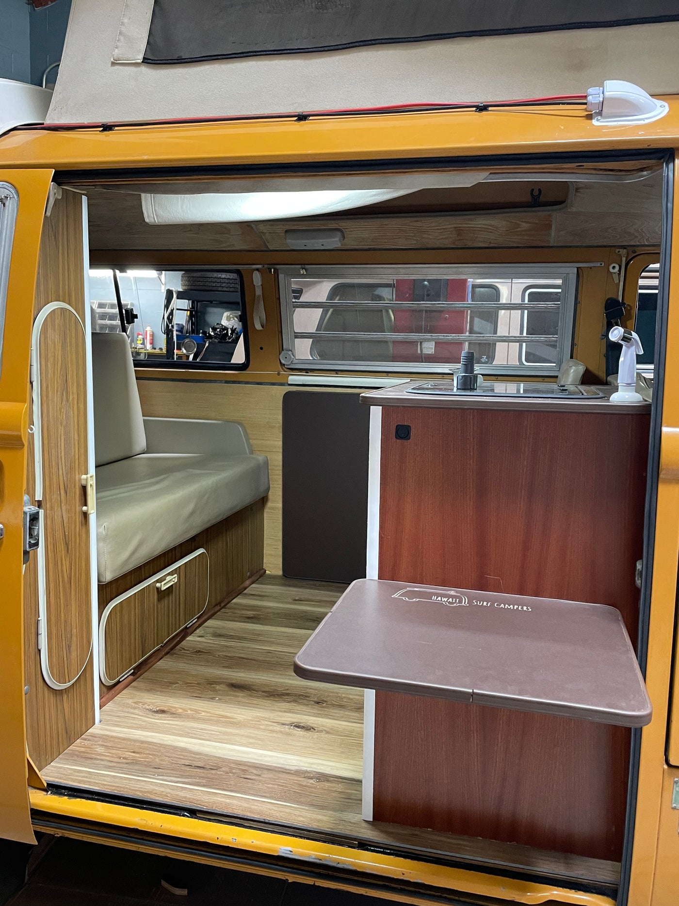 Step inside this RV rental to see its spacious interior with a folding table, wood-look floor, and comfortable seating. — photo 6