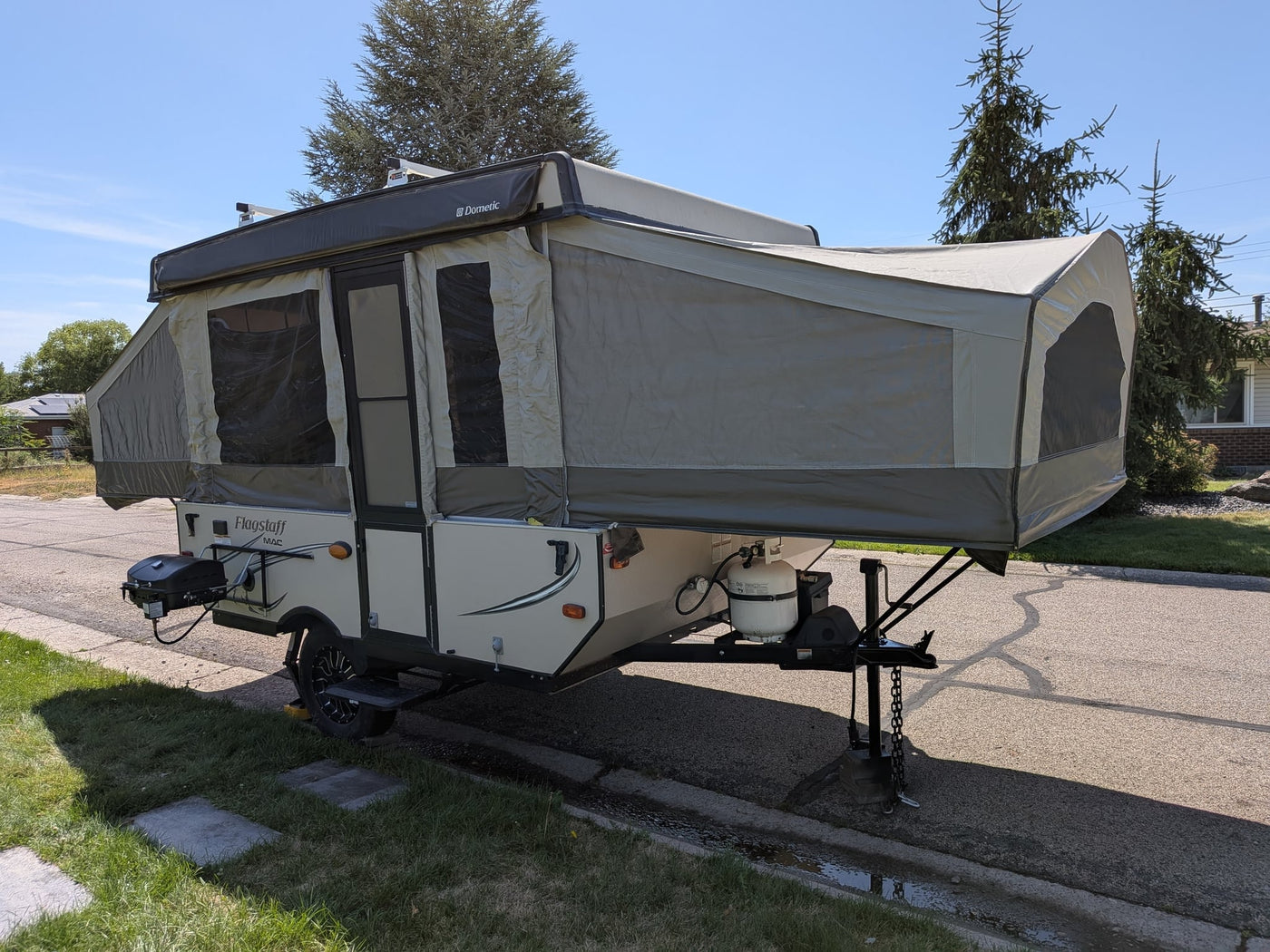 features an outdoor grill and Dometic awning.|Fully set up Flagstaff pop-up camper — photo 3