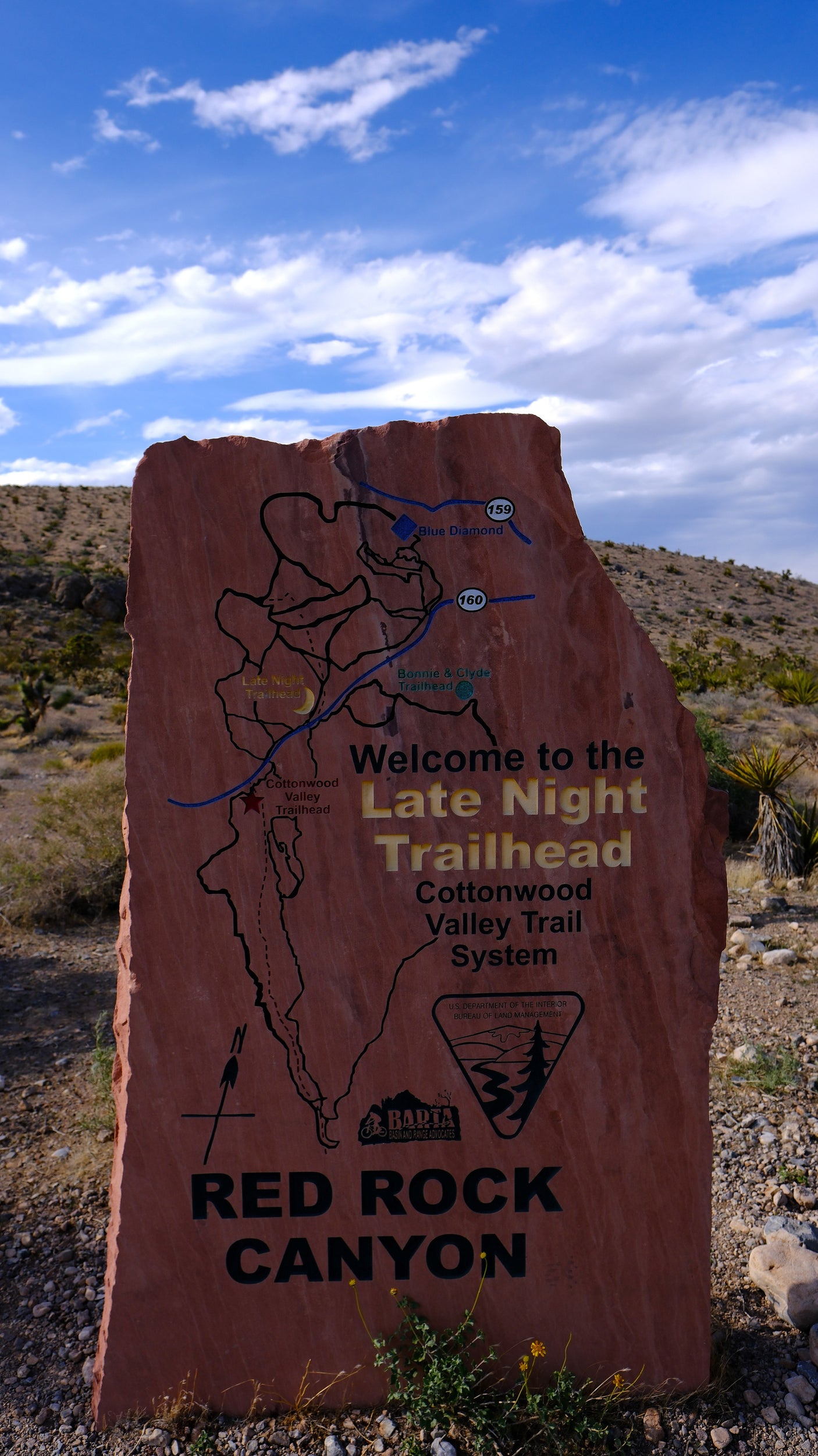 A large stone sign at Red Rock Canyon's Late Night Trailhead shows a trail map, useful for rv rental adventurers.