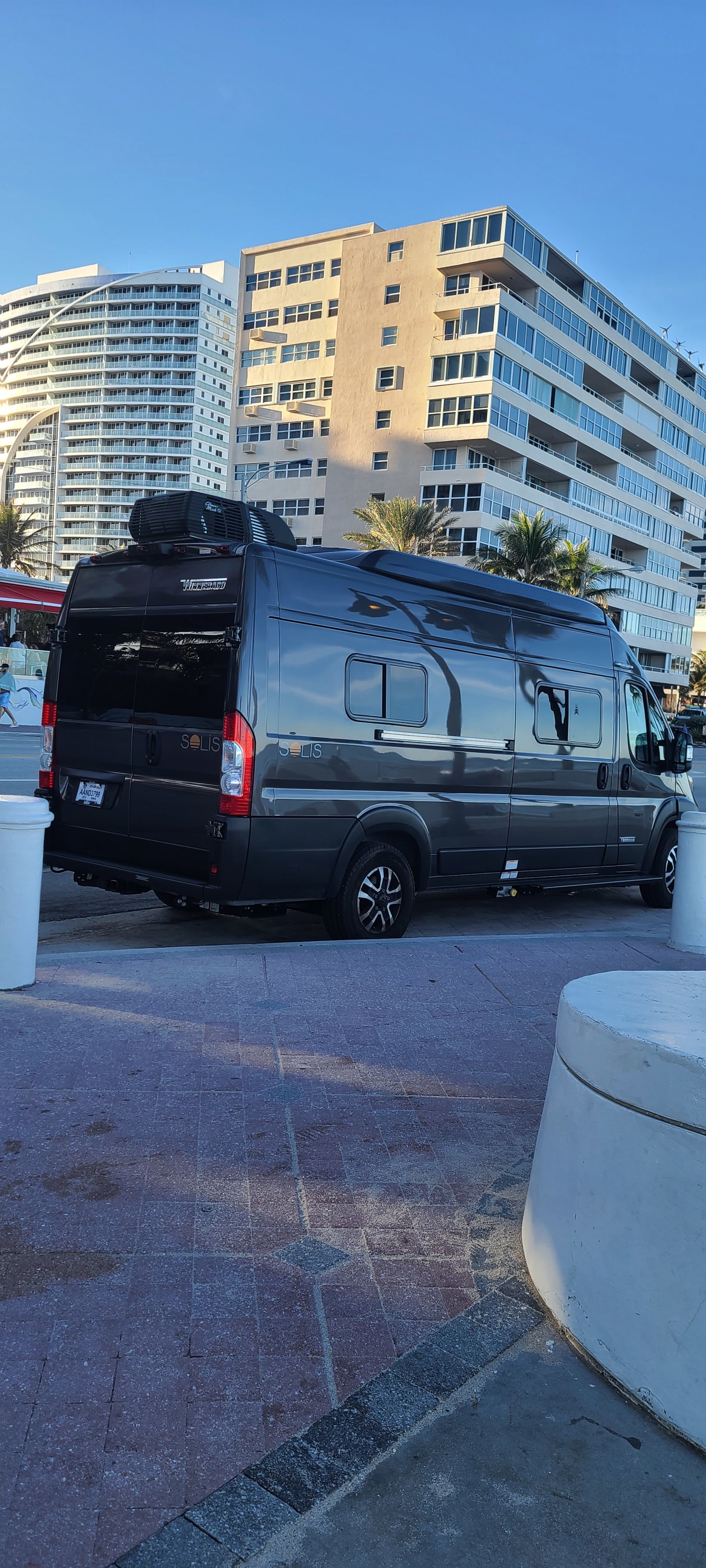 and road. Ideal for beach travel.|A sleek Winnebago Solis camper van