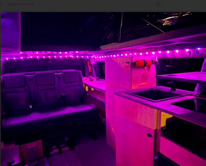 Step inside this cozy RV rental! Features rear seats, built-in kitchen with sink/stove, and ambient LED lighting.