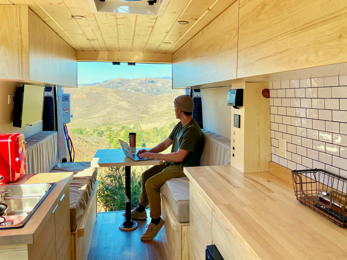 Work remotely from your RV rental! Enjoy stunning mountain views from this modern camper van's comfortable interior.