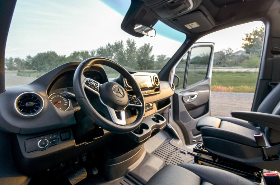 and a private bathroom.|RV rental interior: cozy camper van with a compact kitchen