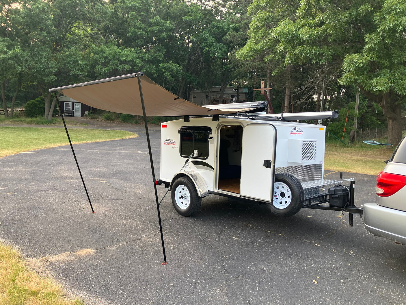 This compact Runaway camper with an extended awning is perfect for your next RV rental adventure.