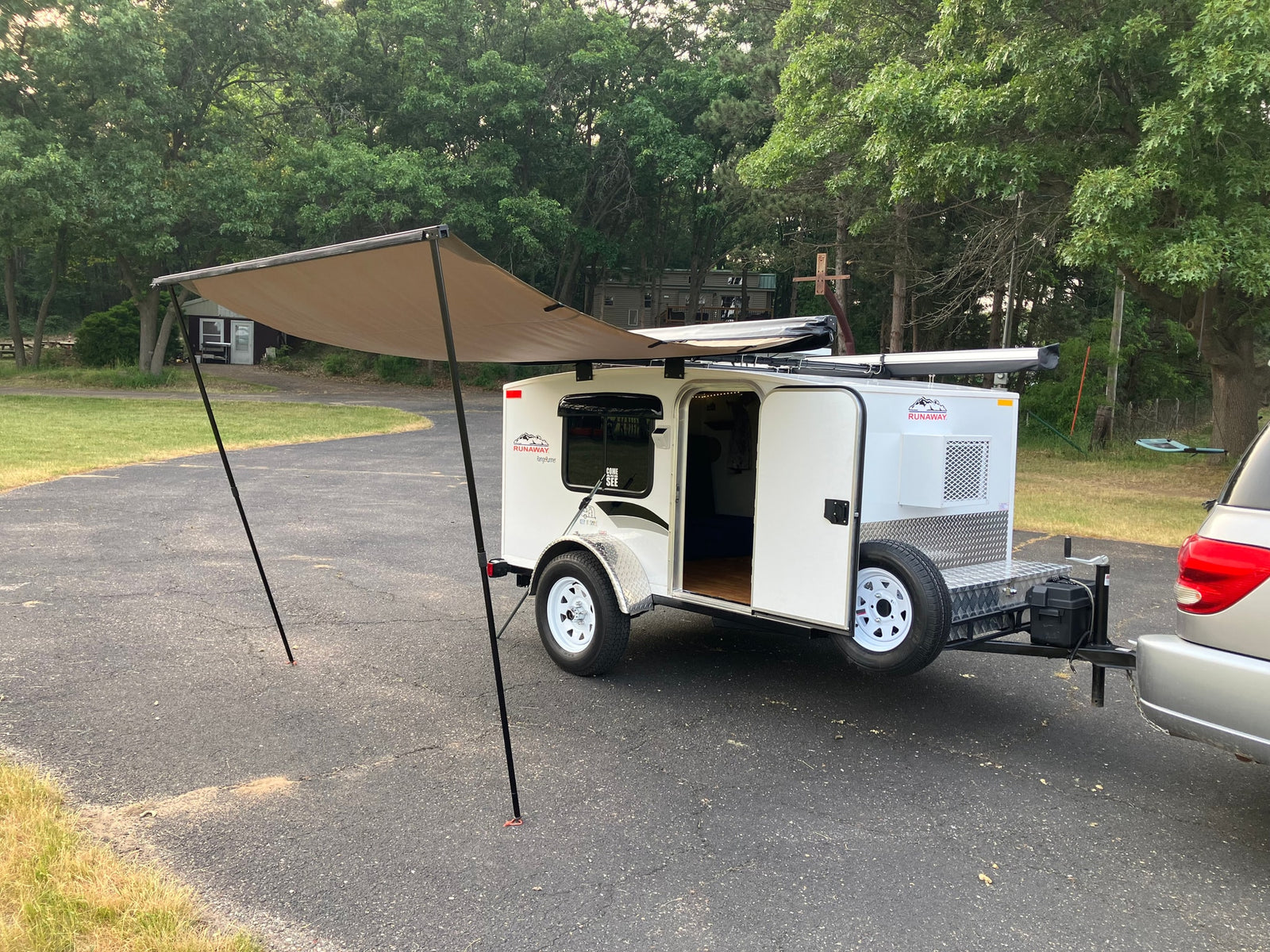 This compact Runaway camper with an extended awning is perfect for your next RV rental adventure.