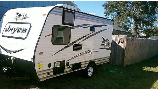 provides a comfortable campsite experience. A man stands by the open door