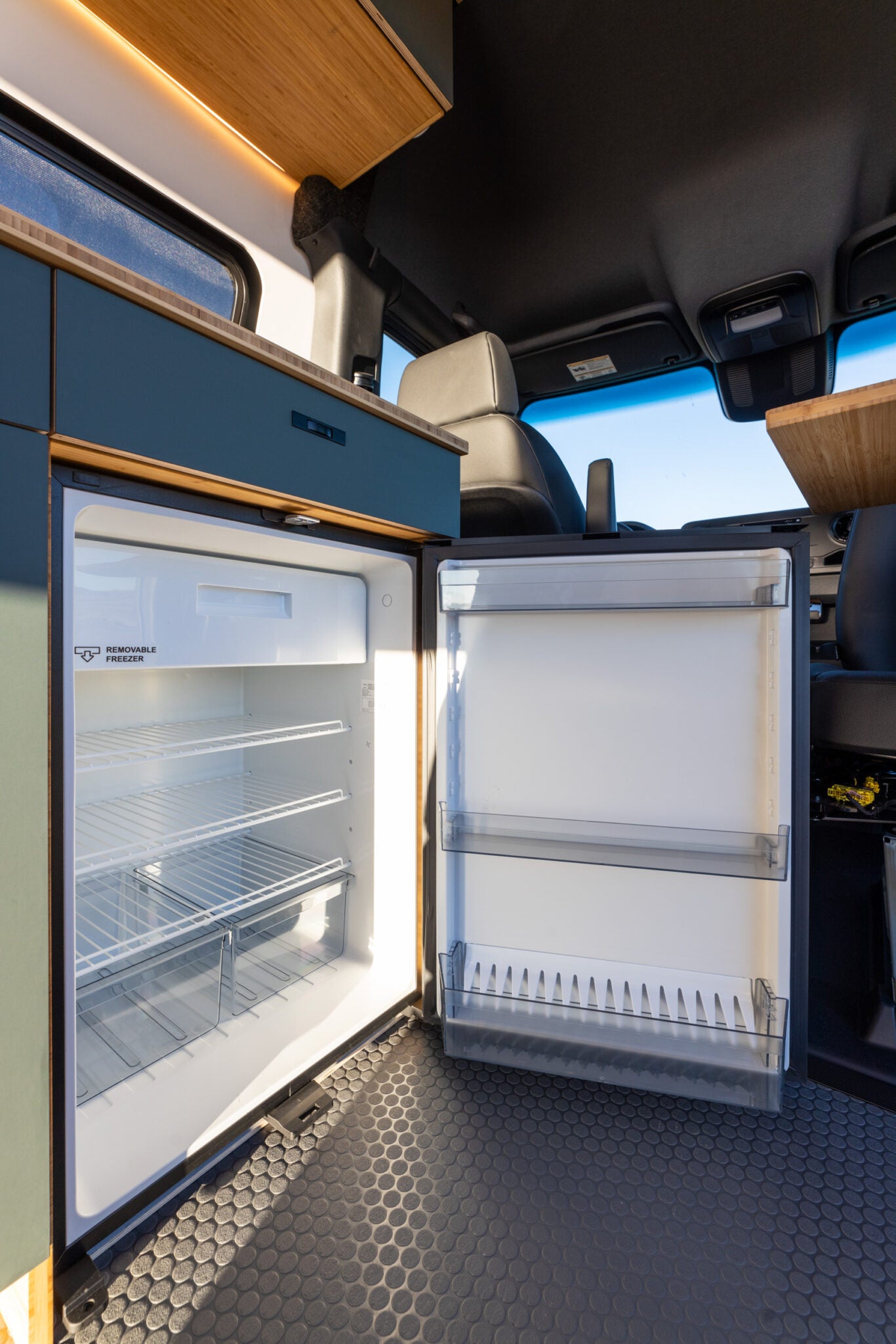 side door open showing interior. Ideal for scenic travel & van life.|Spacious RV rental van interior featuring a modern cockpit
