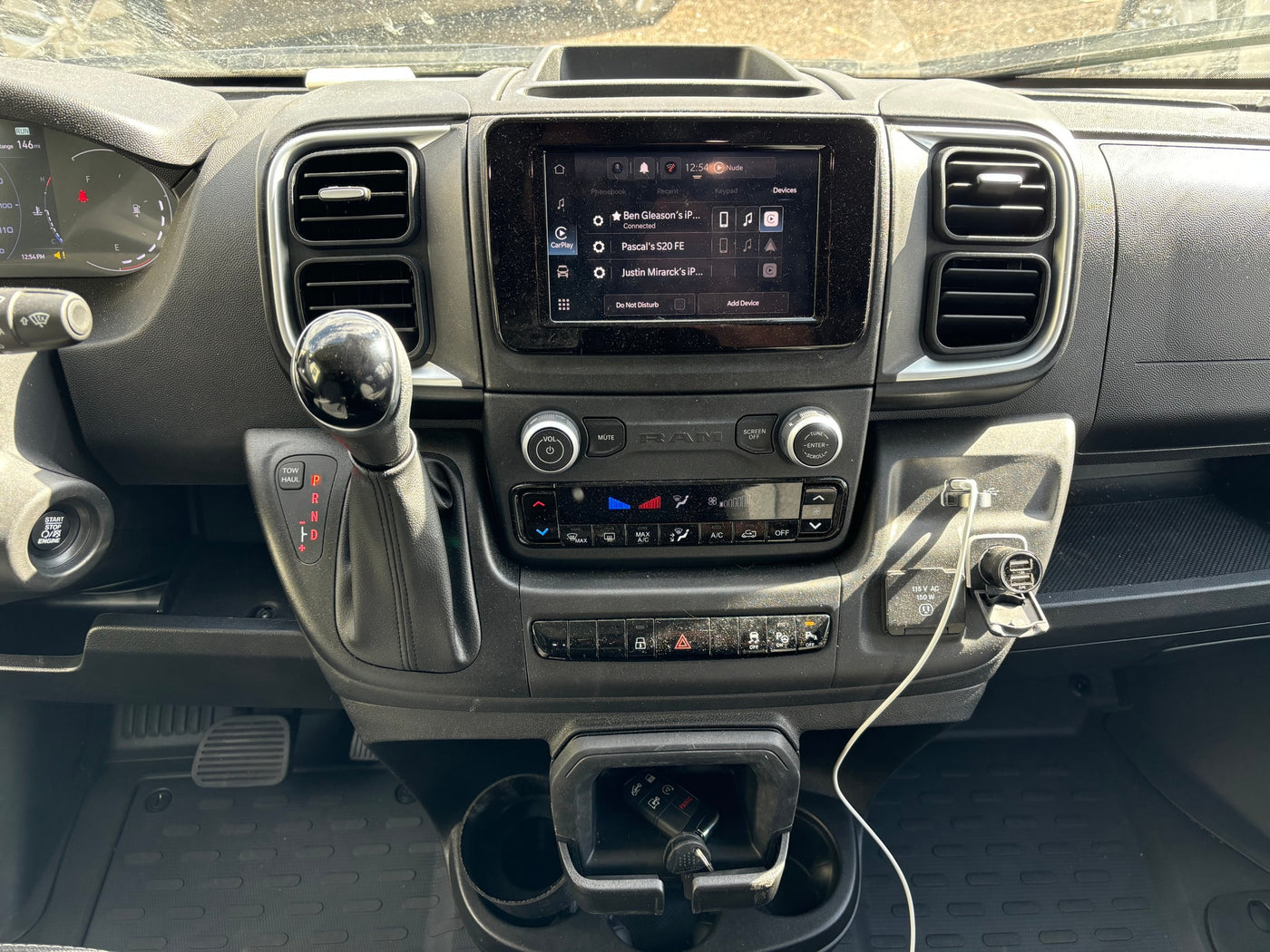 RV rental dashboard with infotainment screen, gear shifter, climate controls, and charging ports. Modern vehicle interior. — photo 12