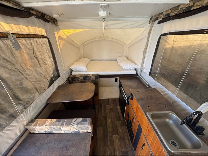 parked on a driveway.|This Comet Starcraft pop-up camper