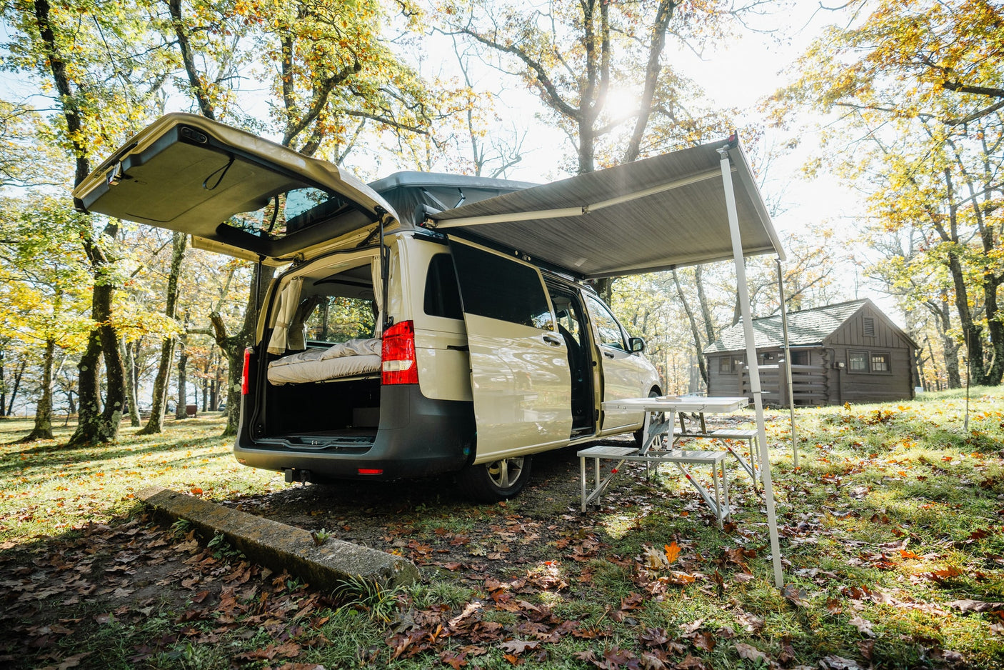 with a grill setup.|RV rental van on a scenic autumn road
