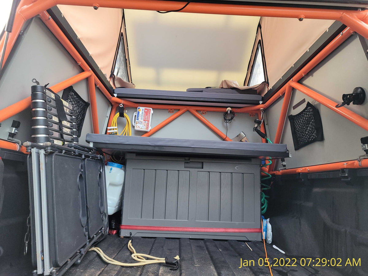 perfect for an RV rental camping experience. Note the bed and storage area.|Interior of an RV rental pop-top camper. Features a sleeping platform — photo 7