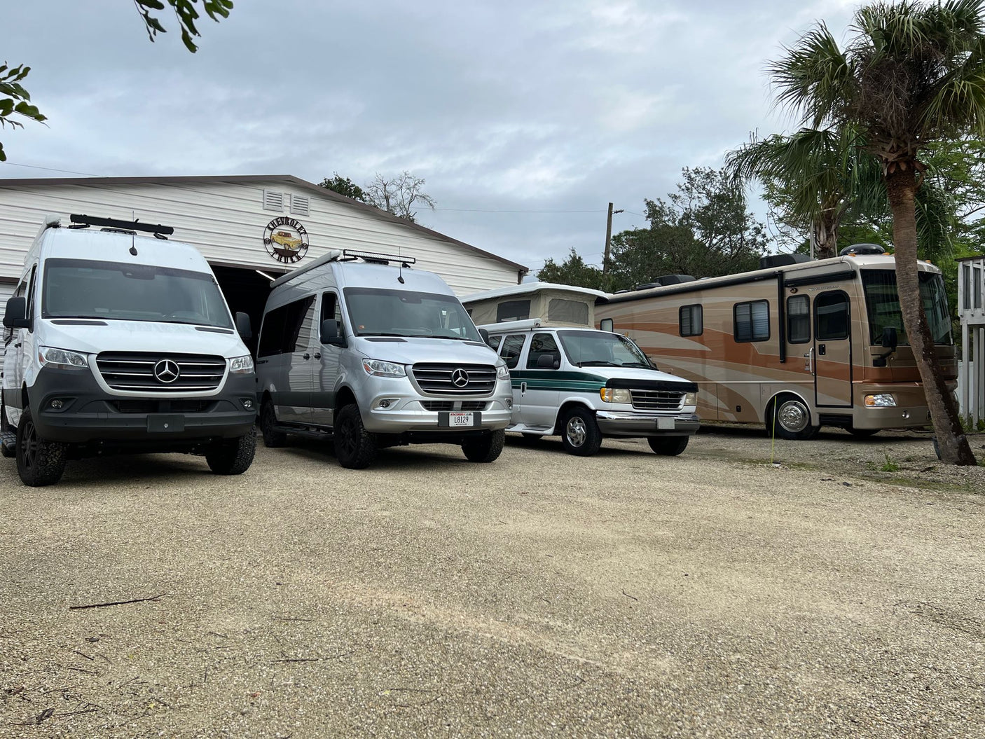 and overhead storage.|Cozy RV rental bedroom featuring a comfortable bed with soft bedding