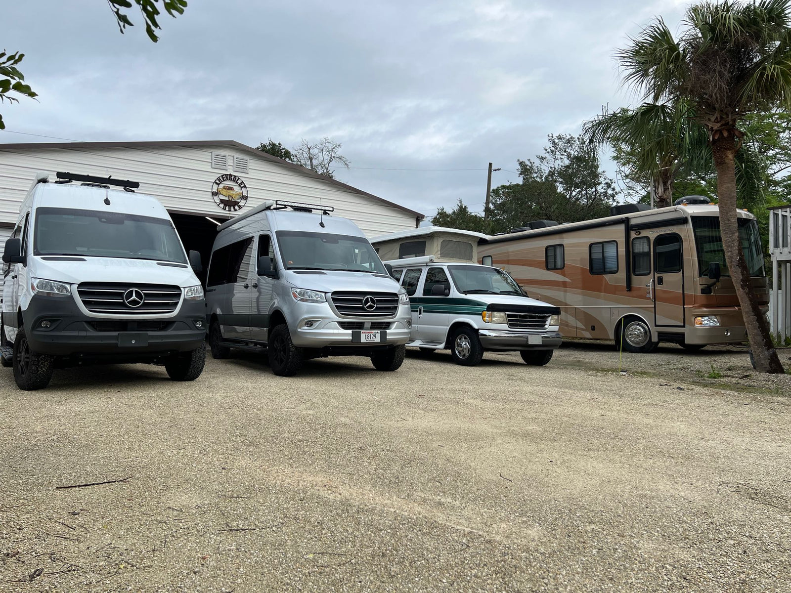 and overhead storage.|Cozy RV rental bedroom featuring a comfortable bed with soft bedding