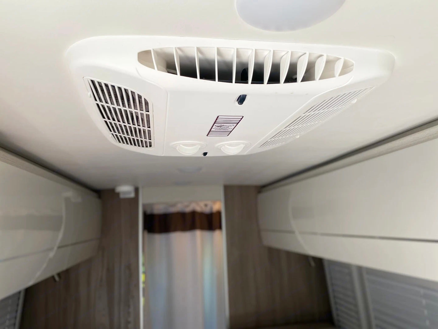 and convertible bed/seating.|Bright rv rental interior: compact kitchen (sink