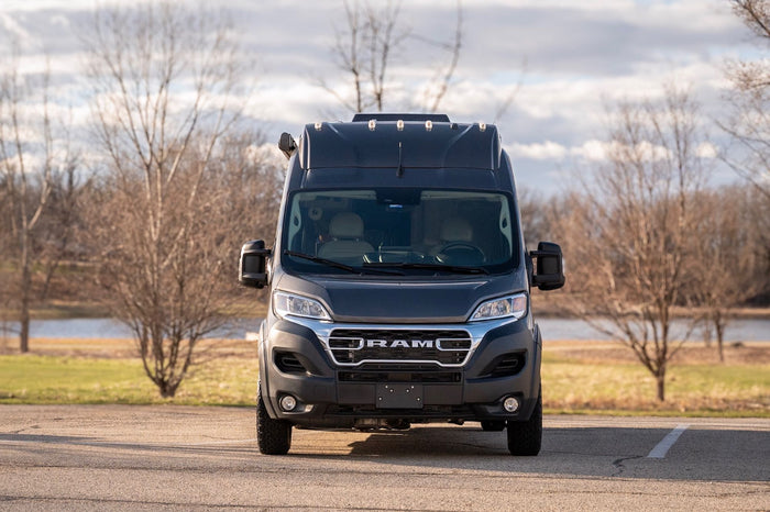 and cozy seating in a compact camper.|Ultimate relaxation in an RV rental: feet up on the bed