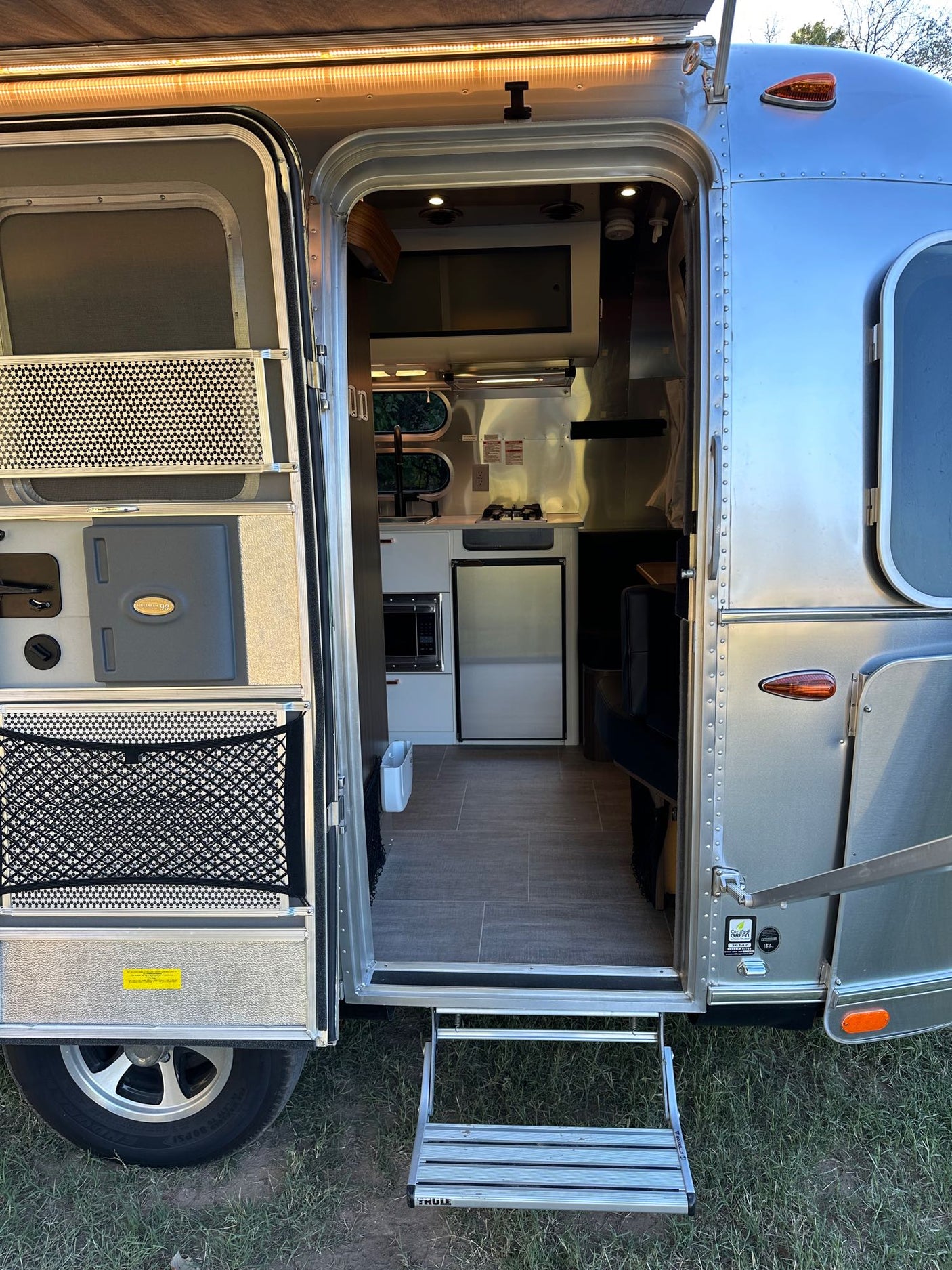 compact kitchen & dinette.|Modern rv rental interior: compact kitchen with stove
