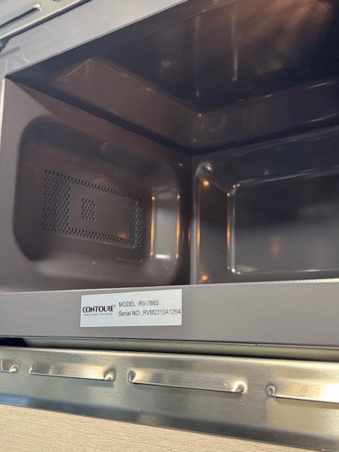 and an overhead monitor for mobile living.|This RV rental features a compact bathroom with a toilet — photo 12
