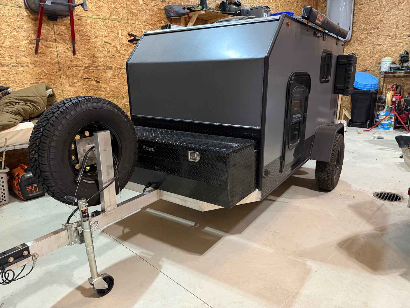 Explore the outdoors! This compact off-road camper trailer, perfect for your next rv rental adventure, boasts a spare tire and utility box.