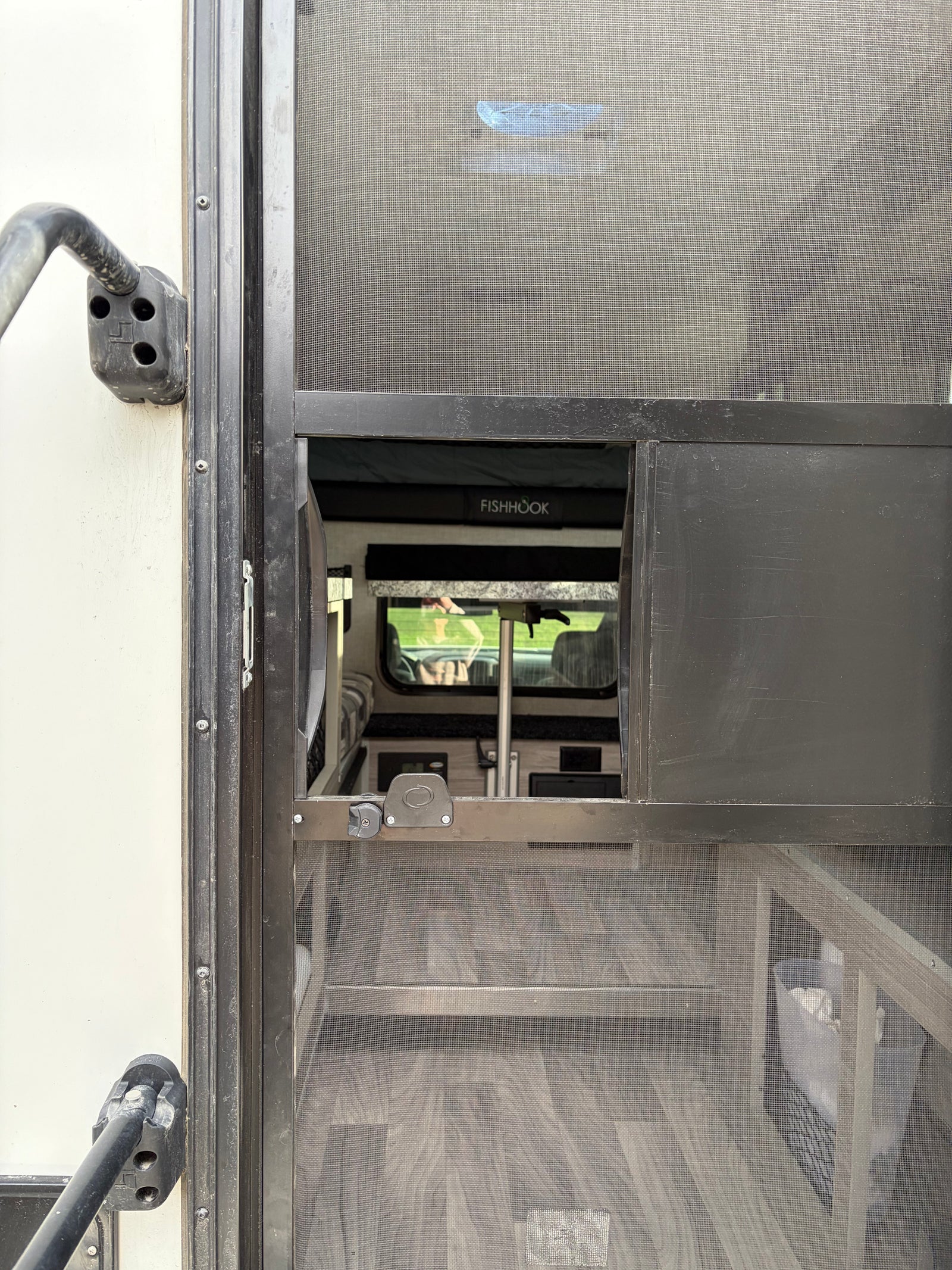 mountainous landscape.|Explore snowy Alaska in this Chevy Silverado rv rental with a gray FISHHOOK truck camper. Ideal for your next outdoor adventure!|Rear view of a FISHHOOK truck camper on a pickup in snow. Its open door reveals the interior