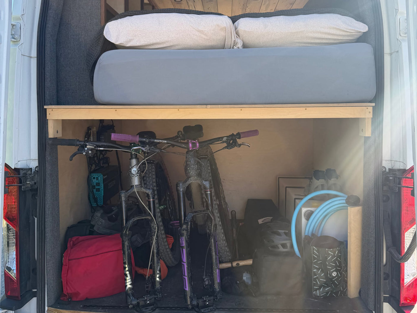 and beautiful wooden accents for your adventure.|Modern RV rental: a custom van interior with a wood kitchen